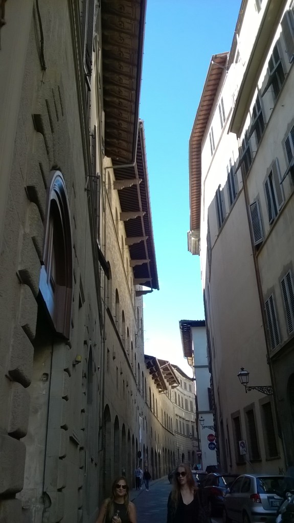 Negative space and overhanging roofs. Bemused locals in the foreground